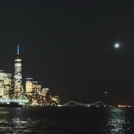 a large body of water with a city in the background