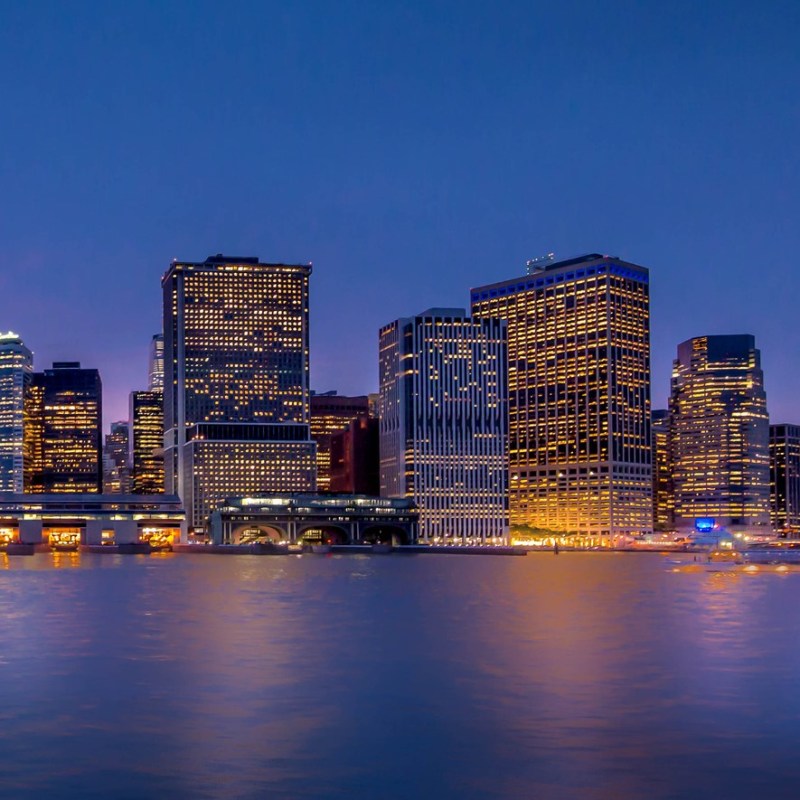 harbor lights cruise of new york city with skyline reflected on the water