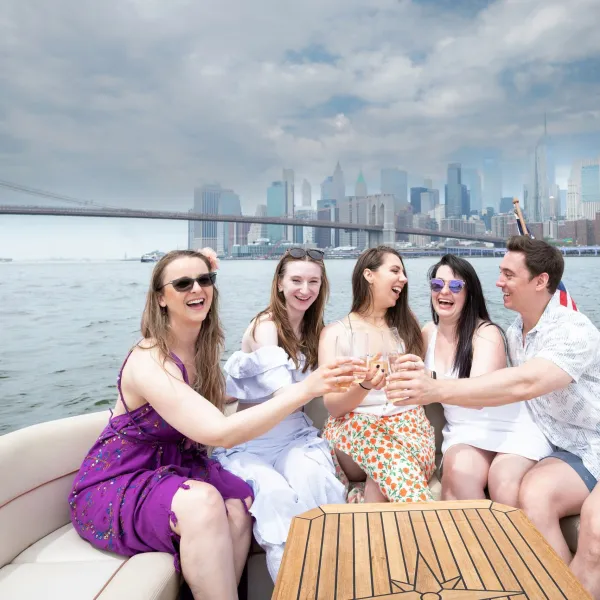 friends making a champagne toast during a luxury yacht charter in NYC
