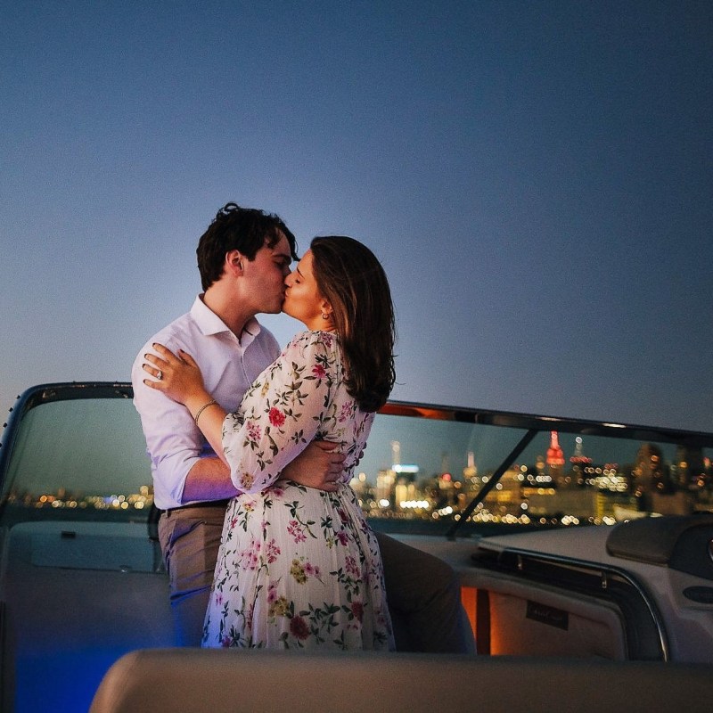couple kissing during a night cruise in NYC