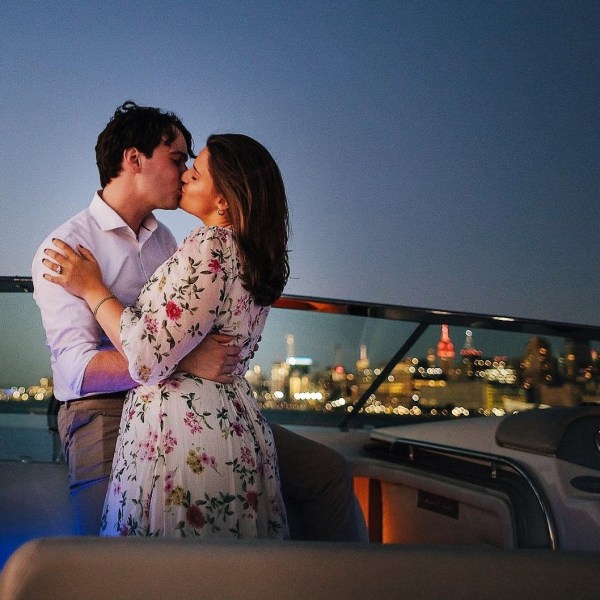 couple kissing during a night cruise in NYC