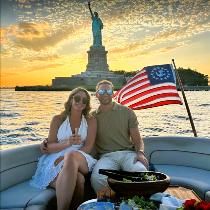 man and a woman during a sunset cruise NY after a surprise marriage proposal on a boat