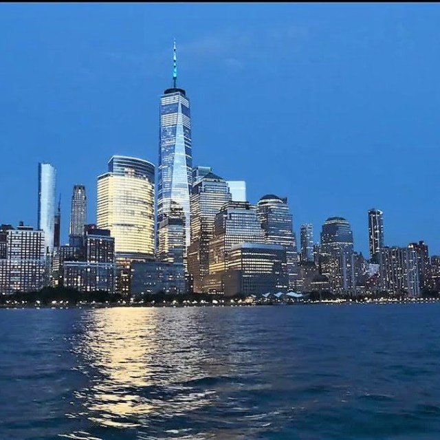 Hudson River and the World Trade Tower in the Financial District and Tribeca during a night boat ride in NYC