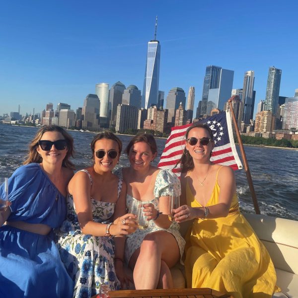 friends on a NYC sunset cruise with Manhattan skyline in the background
