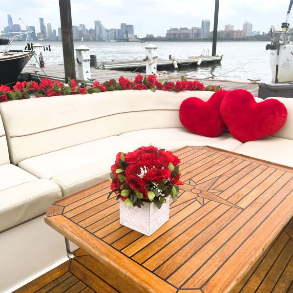 heart pillows and red roses decorating a romantic cruise in NYC