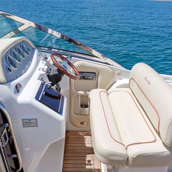 white captain's bench and steering wheel and control panels on NYC boat rentals