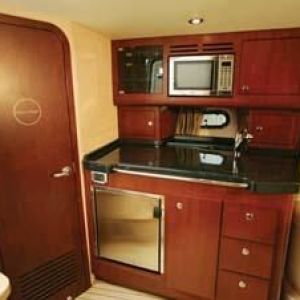 a kitchen with stainless steel appliances and wooden cabinets on private boat rides in NYC