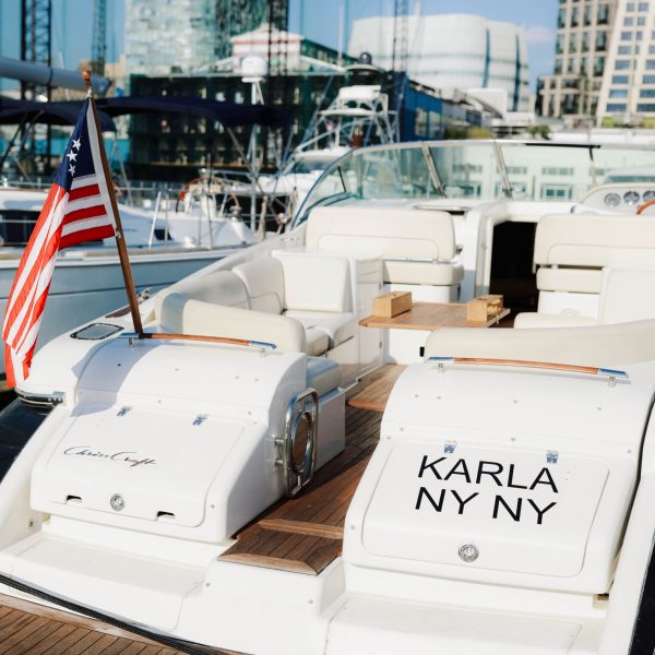 New York yacht rental named Karla with American flag at the stern docked next to the Chelsea Piers Golf Club