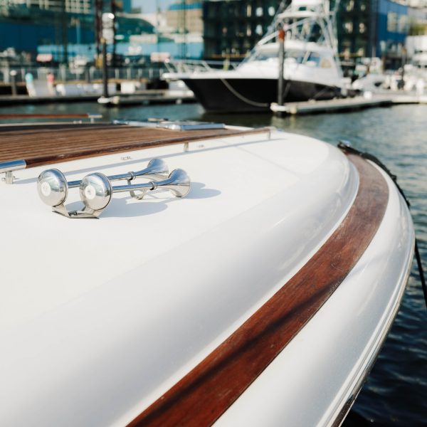 pair of silver horns on the bow of a NYC yacht rental in the Chelsea Piers boat marina