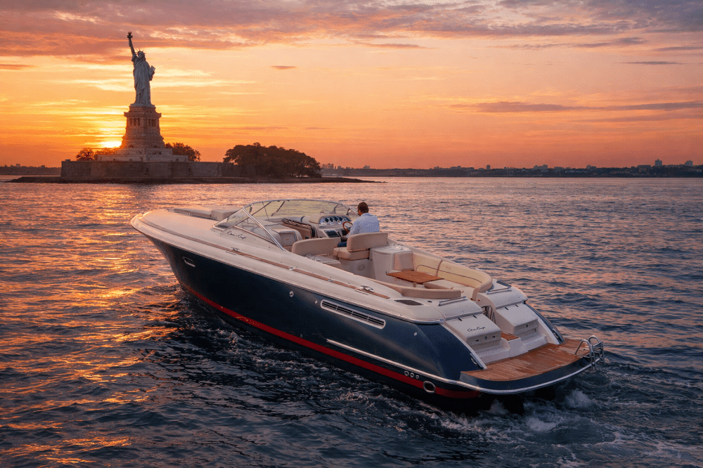 Boat on water near Statue of Liberty at sunset in NYC