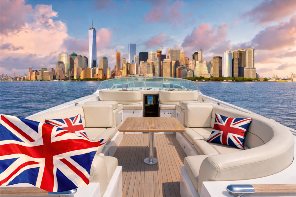 Open private yacht charter with Union Jack cushions and flag facing the Manhattan skyline on a sunny day.